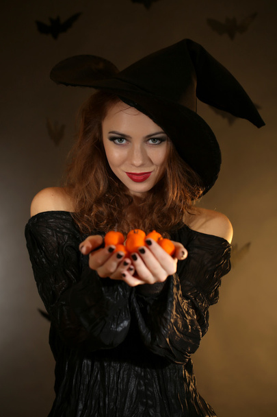 Halloween witch on dark background - Fotoğraf, Görsel