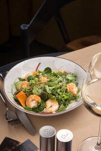 Shrimp salad, lettuce, cucumber, spinach olive oil. fresh healthy shrimps salad. Close up view on Salad. Healthy, diet tasty summer dish - Photo, Image