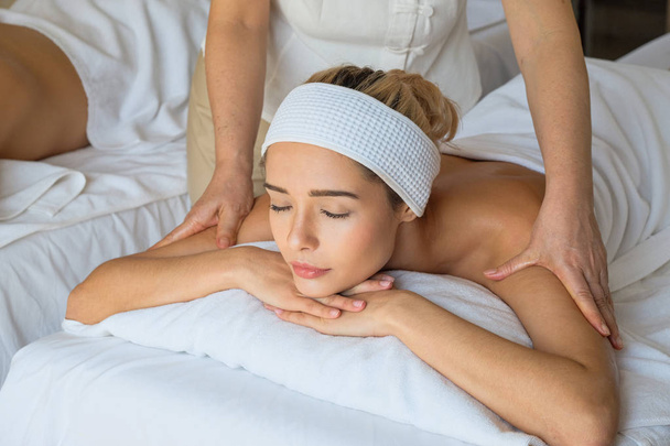 beautiful woman during massage with essential oil in room spa - Photo, image