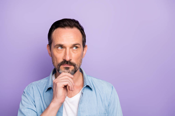 Close up photo of minded man feel pensive emotion think work thoughts look copyspace touch chin fingers wear stylish modern clothes isolated over violet color background - Foto, imagen