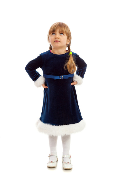 Little girl in dark blue dress looking up - Foto, afbeelding