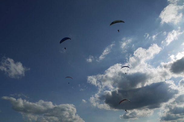 Paragliding is the recreational and competitive adventure sport  - Фото, изображение