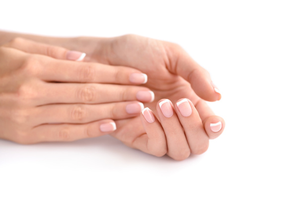 Piękna kobieta ręce z francuskim manicure na białym tle - Zdjęcie, obraz