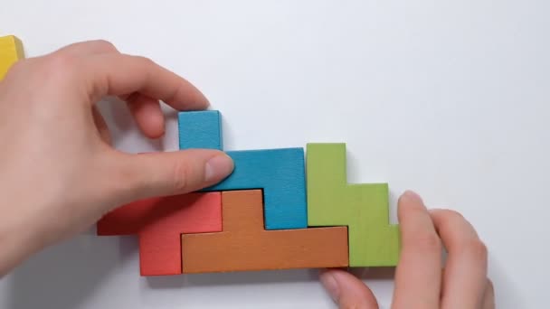 Sluiten Slow motion. Een stuk houten blokpuzzel. stapelen van houten blokjes. Concept van complex en slim logisch denken. - Video
