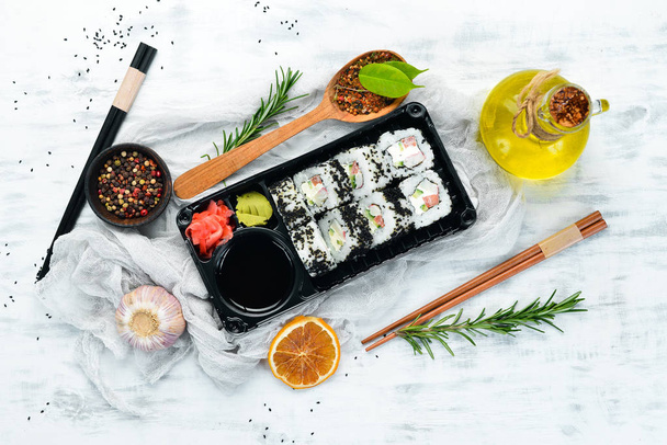Food delivery. Sushi rolls with caviar and crab. Soy sauce, wasabi. Top view. free space for your text. Asian cuisine. - Фото, изображение