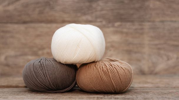 Close up of wool knitting on wooden background - Fotografie, Obrázek
