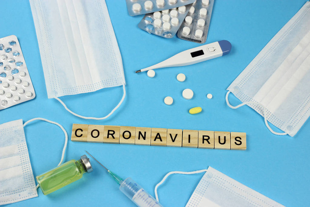 Chinese 2019 outbreak of coronavirus-nCoV. The inscription word Coronavirus, thermometer, syringe, pills, gauze bandage. MERS-Cov middle East respiratory syndrome - Fotografie, Obrázek
