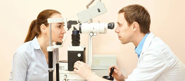 ophthalmologist doctor in exam optician laboratory with male patient. Men eye care medical diagnostic. Eyelid treatment - Foto, immagini