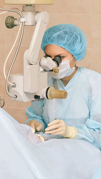 Ophthalmology laser microscope operation. Doctor in clinic. Patient eye treatment. Myopia and cataract removal - Fotó, kép