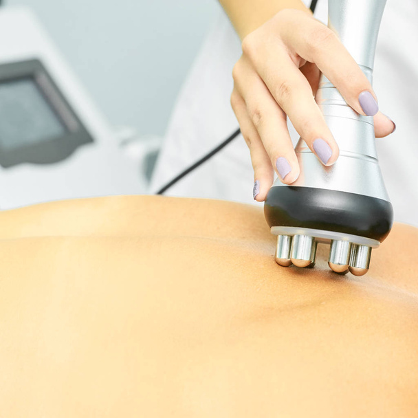 Perfect body radio treatment. Woman at spa procedure. Doctor hand and girl body. RF cosmetology lifting - Zdjęcie, obraz
