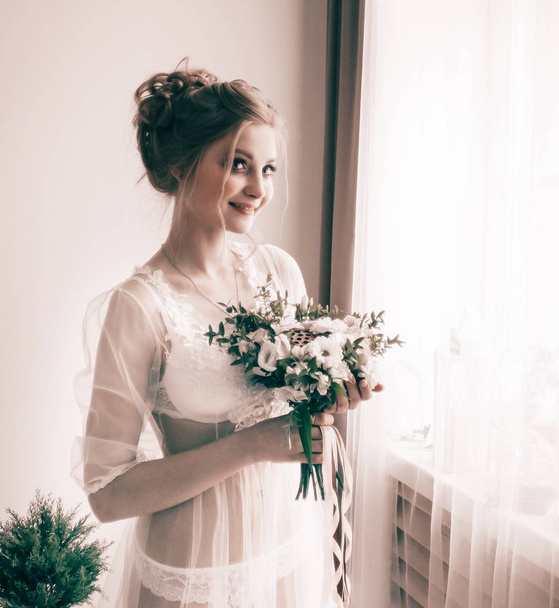 Nice girl with a bouquet on her wedding day. - Fotó, kép