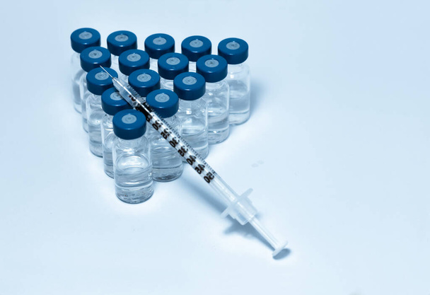 Glass medicine bottles with injection fluid with blue aluminium  - Фото, зображення