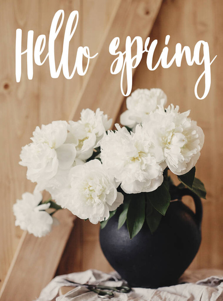 Hello Spring text handwritten on stylish peony bouquet in black  - Foto, Bild