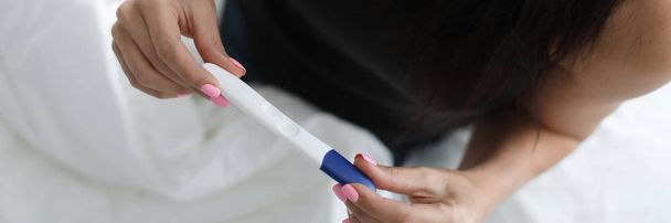 Woman holding pregnancy test results - Photo, Image