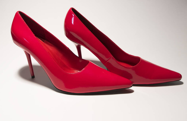 red female shoes on white background - 写真・画像