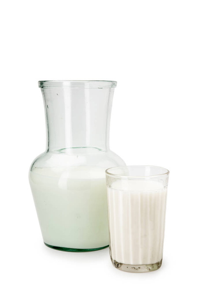 Milk in a glass decanter, glass on a white background - Foto, afbeelding