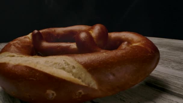 Hot pretzel placed on timber table. - Footage, Video