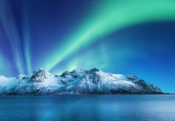 Aurora Borealis, Isole Lofoten, Norvegia. Luci nordiche, montagne e riflessione sull'acqua. Paesaggio invernale durante le luci polari. Norvegia viaggi - immagine - Foto, immagini