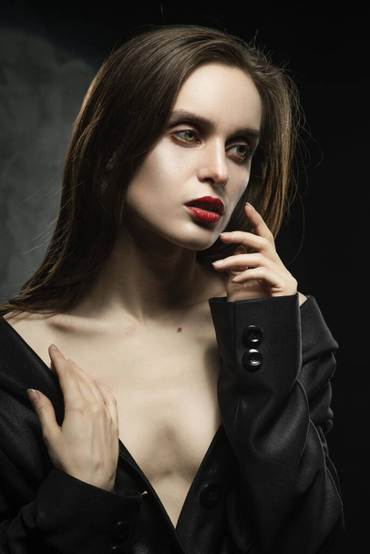 Beautiful braless slim girl, wearing a unbuttoned black blazer,  - Zdjęcie, obraz