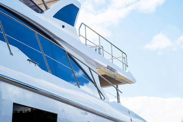 Nautical background of luxury yachts, with black tinted windows and chrome metal railings on white fiber glass bows - Φωτογραφία, εικόνα