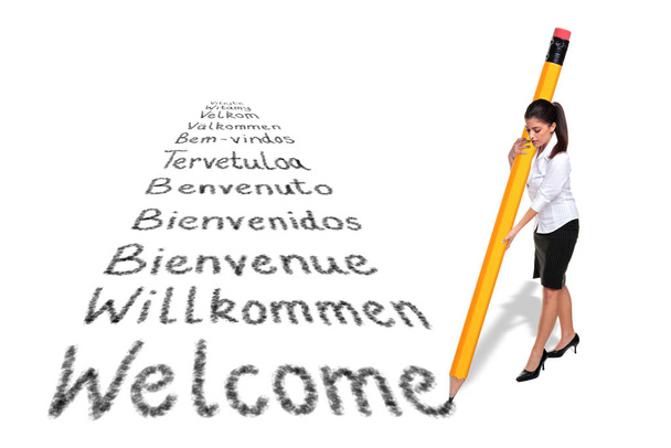 Businesswoman writing Welcome in various languages with a giant - Zdjęcie, obraz