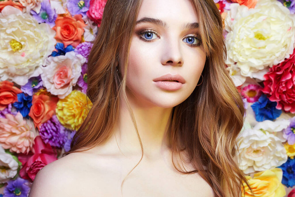 beautiful woman in flowers. colorful floral background - Fotoğraf, Görsel