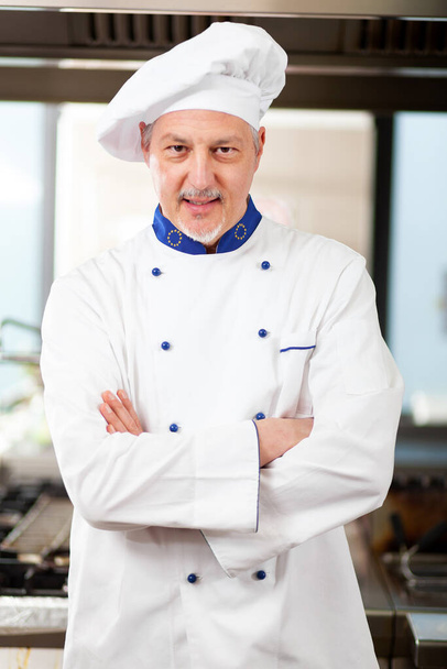 Portrait of a Chef at work in his Kitchen - Foto, Imagem