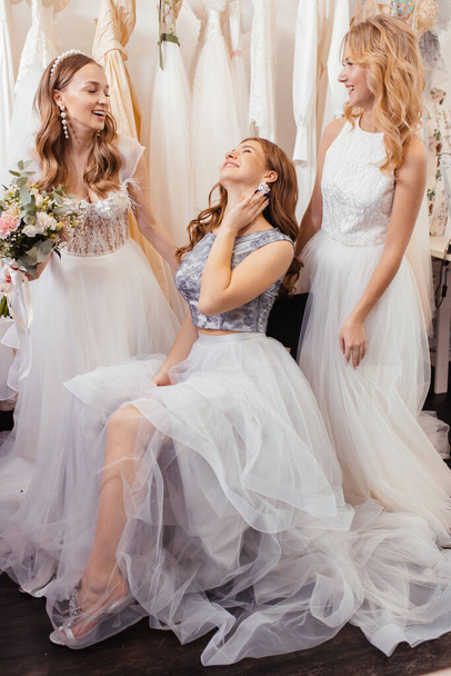 good-looking three women together in wedding dresses - Foto, imagen