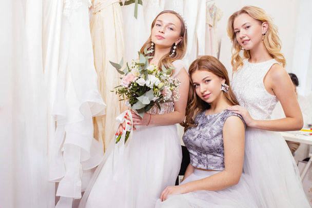 three caucasian brides with beautiful hair and makeup posing in salon - Фото, изображение