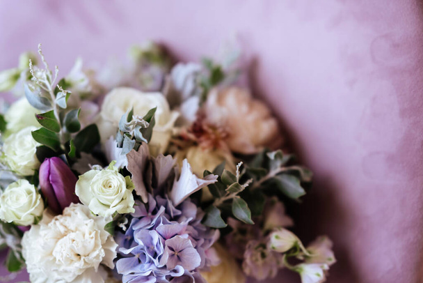 Rich bunch of pink peonies and lilac eustoma roses flowers, green leaf in glass vase. - 写真・画像