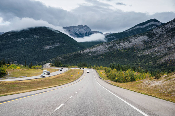 Scenic road trip with rocky mountain in autumn forest at Banff n - Photo, image