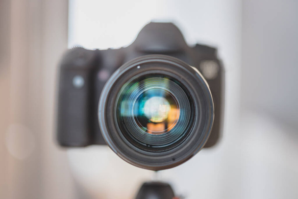Close up of professional photo camera on a tripod, lens - Fotó, kép