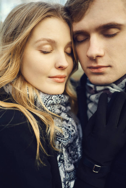 close-up portrait young tenderly romantic couple in love close to each other with eyes closed outdoors. - Foto, imagen
