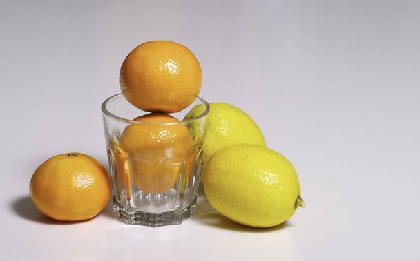 lemon and lime in a glass on a white background - Photo, Image