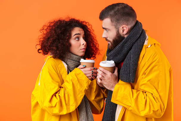 Frozen loving couple holding coffee. - Fotoğraf, Görsel