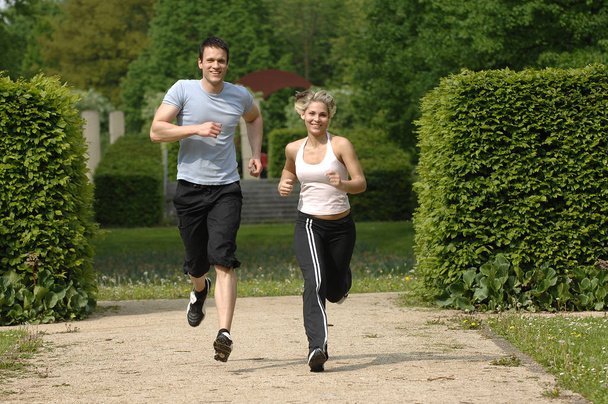 young couple jogging in park - Photo, Image