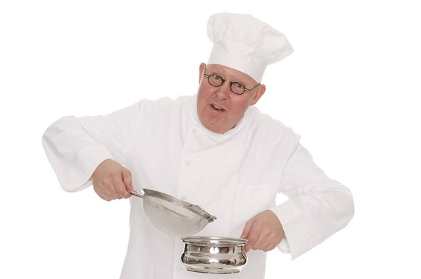 chef in uniform holding a pan isolated on white background - Foto, afbeelding