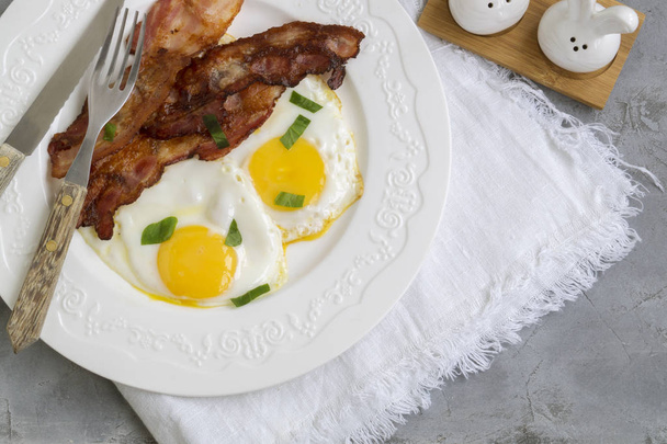 fried eggs with bacon. Sunny side up egg - Photo, Image