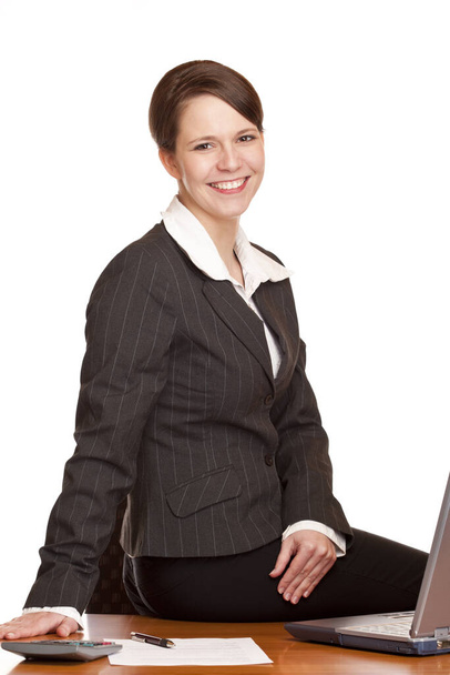 businesswoman sitting in office at desk - Photo, Image