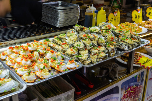 Comida china callejera. Comercio callejero. Tipos chinos de seaf fresco
 - Foto, imagen