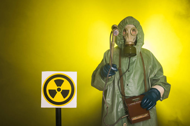 Radiation and danger concept - Man in old protective hazmat suit - Photo, Image