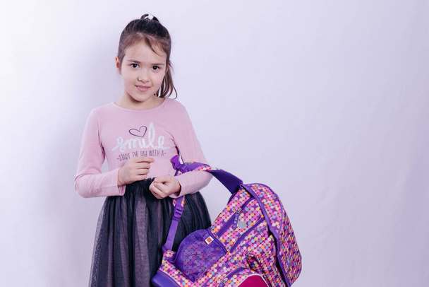 schoolgirl with a school bag on her hand  - 写真・画像