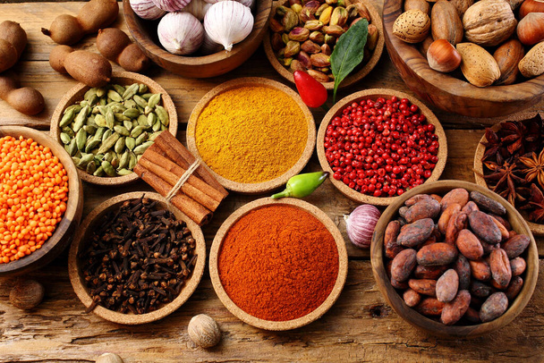 spices and nuts assortments on rustic table background - Fotoğraf, Görsel