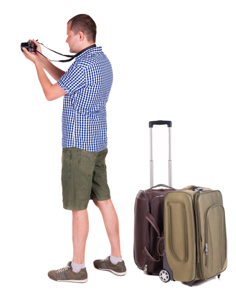 Man photographing traveling with suitcase - Фото, изображение