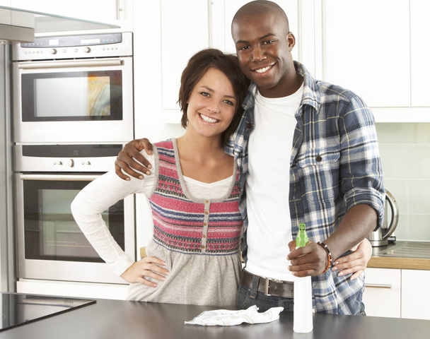 Young Couple Cleaning Cleaning Modern Kitchen - Foto, Imagen