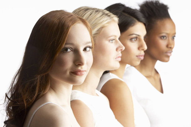Portrait Of Four Attractive Young Women In Studio Standing In Line - Foto, imagen