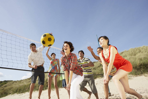 Group Of Teenage Friends Playing Volleyball On Beach - Foto, Bild
