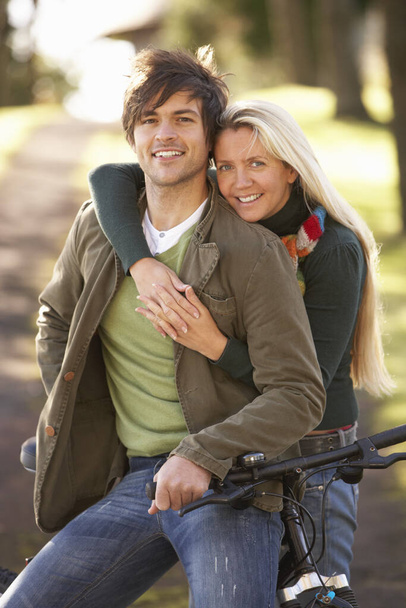 Portrait Of Young Couple With Cycle In Autumn Park - Valokuva, kuva