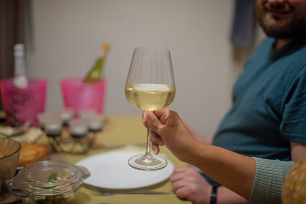 Woman holding glass of wine in hand - Zdjęcie, obraz