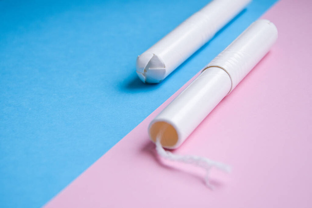 Hygienic tampons on a blue and pink background. copy space, Menstruation sanitary tampon for woman hygiene protection. Critical days. Medical conception - Photo, Image
